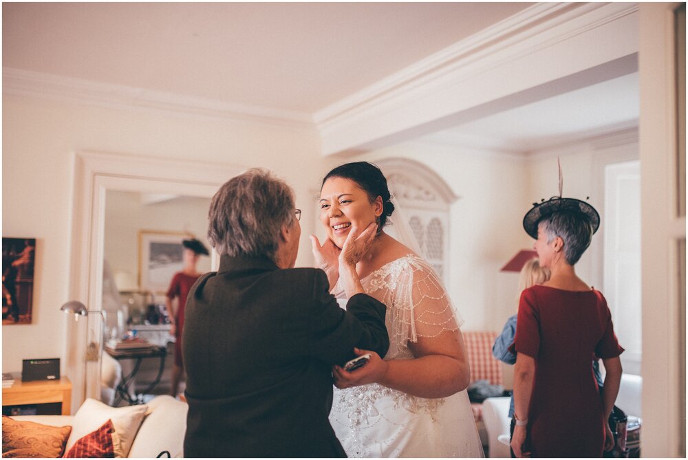 Grandmother squeezes the face of the bride in Melrose elopement.