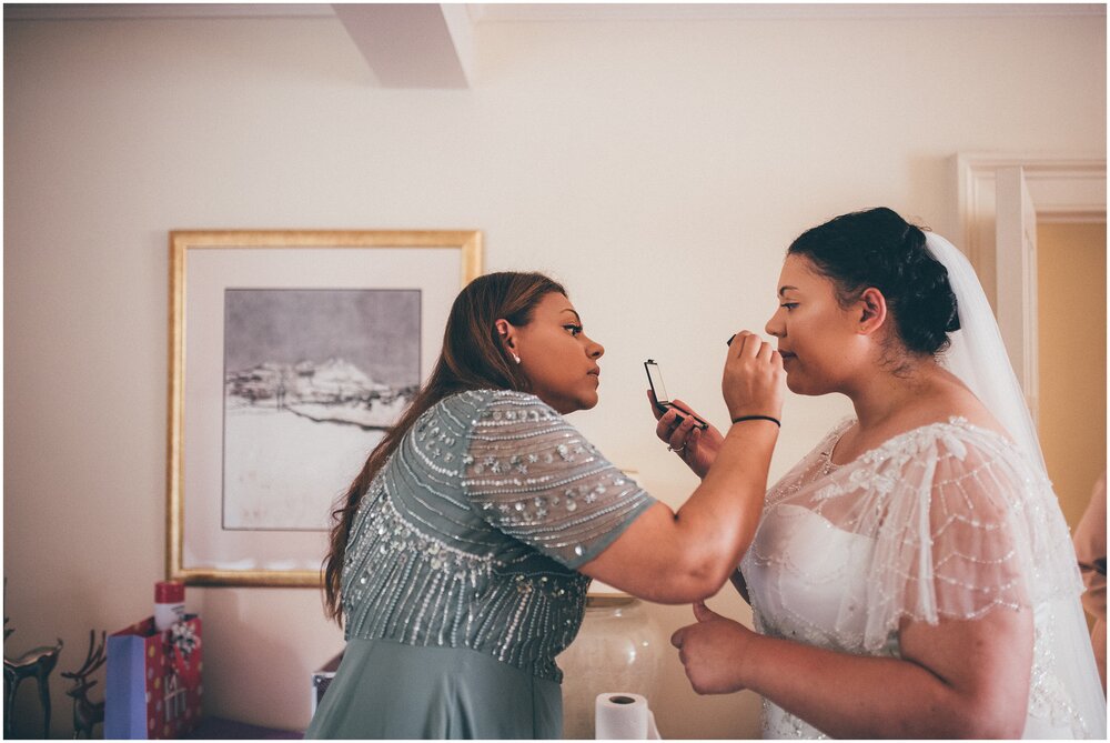 Bride's sister puts finishing touches of  lipstick on the bride before they walk to Melrose Abbey.