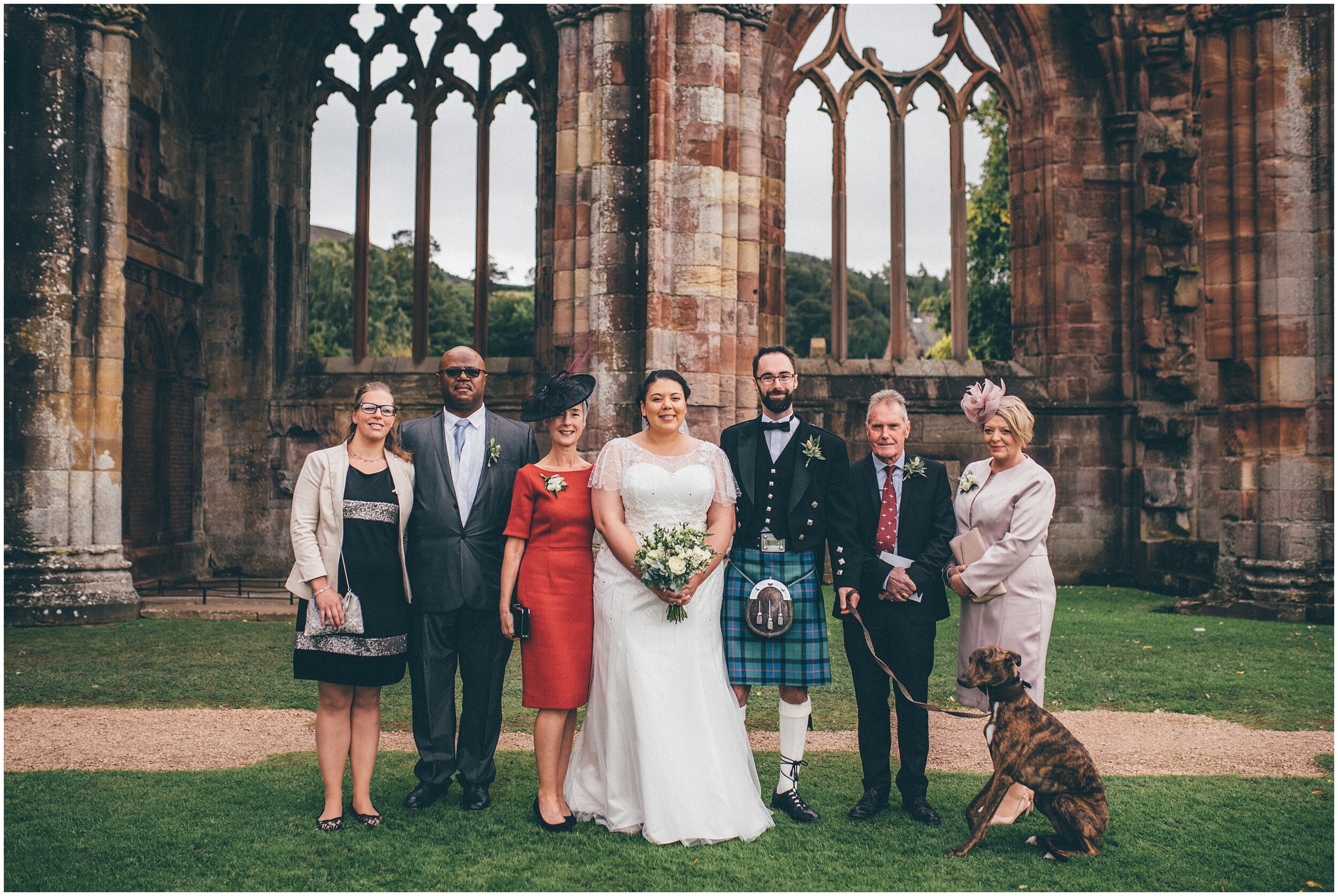 Wedding guests at a wedding in Melrose Abbey on Scottish Borders.