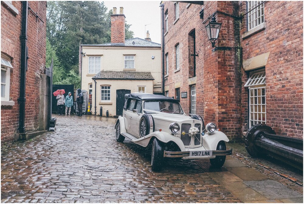 Bride's wedding car arrives at Quarry Bank Mill wedding in Cheshire near to Manchester.