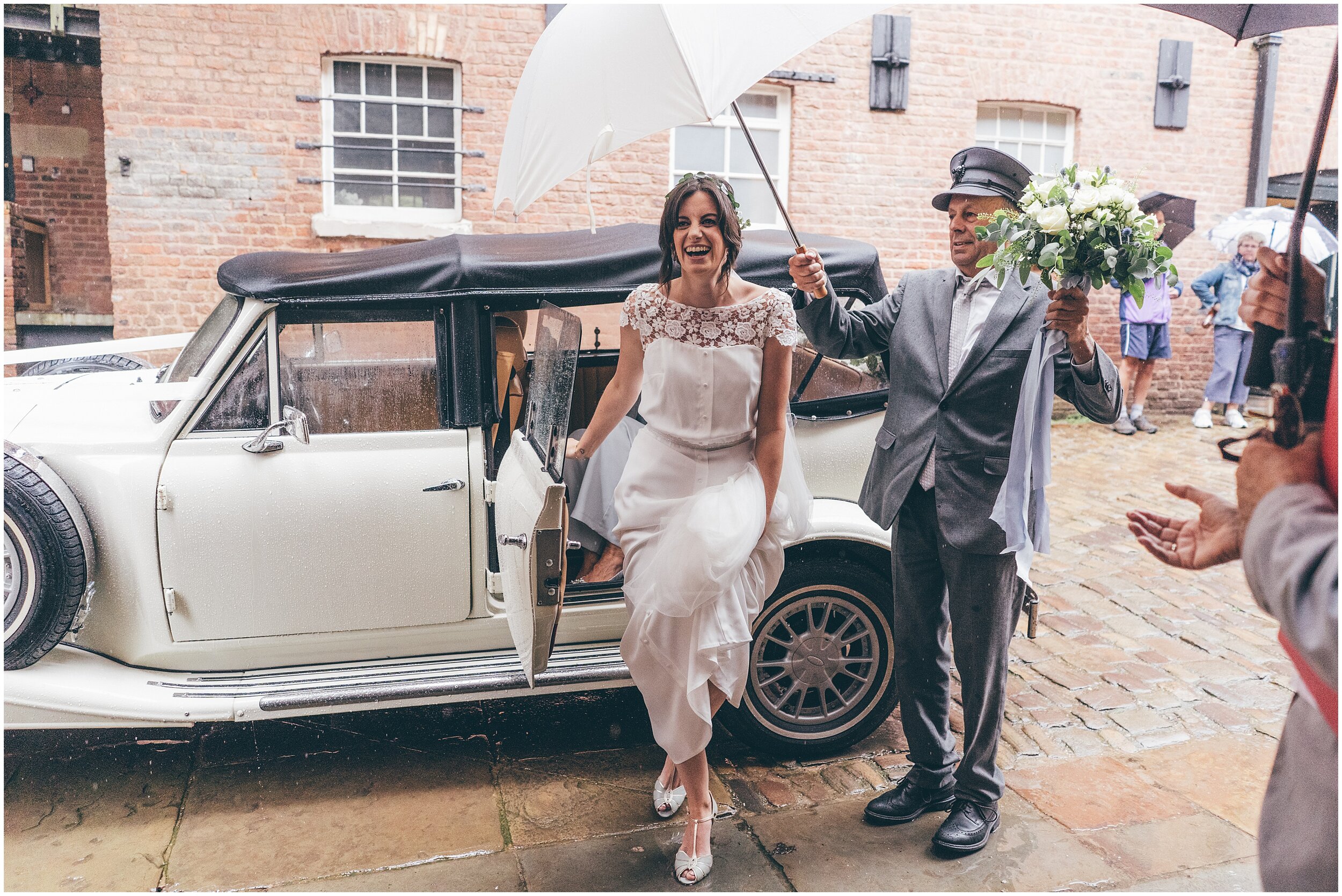 Bride arrives at her wedding at Quarry Bank Mill wedding in Cheshire near to Manchester.