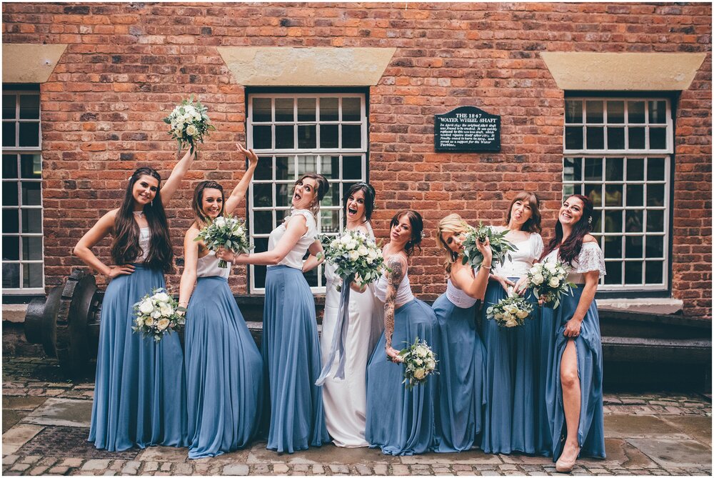 Bride and her bridesmaids pose aat Quarry Bank Mill wedding in Cheshire near to Manchester.