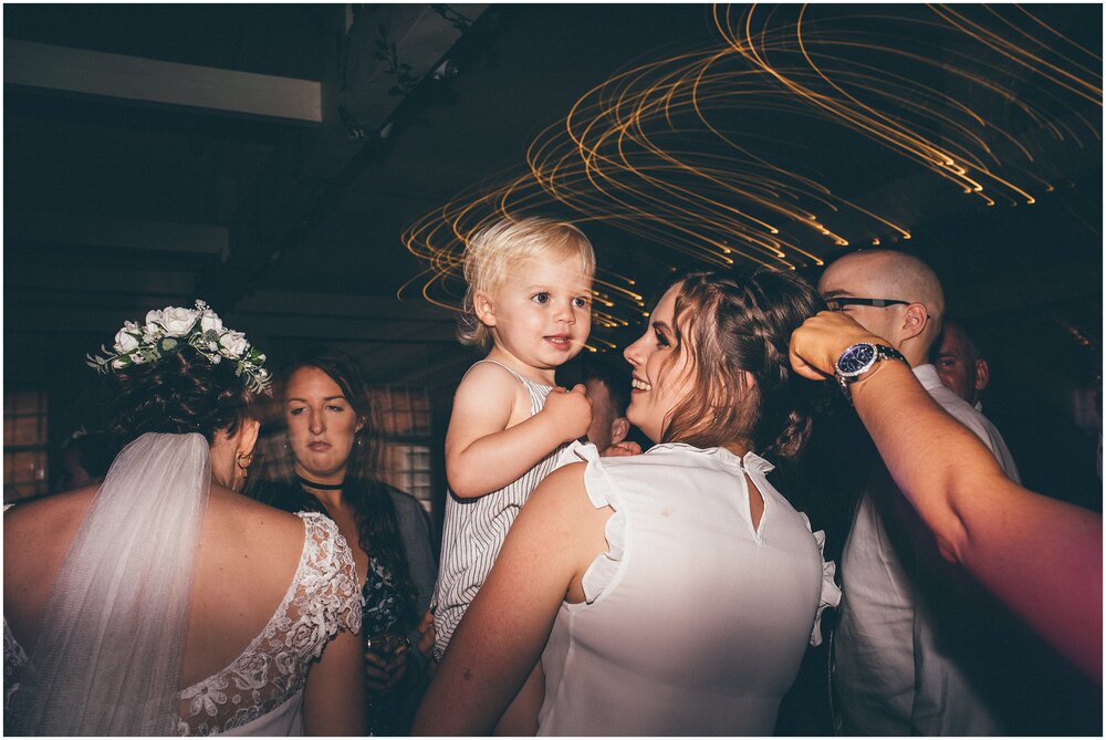 Wedding guests dance and celebrate at Quarry Bank Mill wedding in Cheshire near to Manchester.