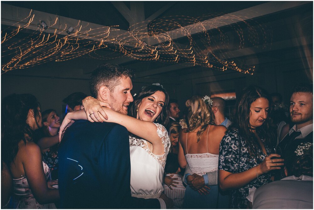 Wedding guests dance and celebrate at Quarry Bank Mill wedding in Cheshire near to Manchester.