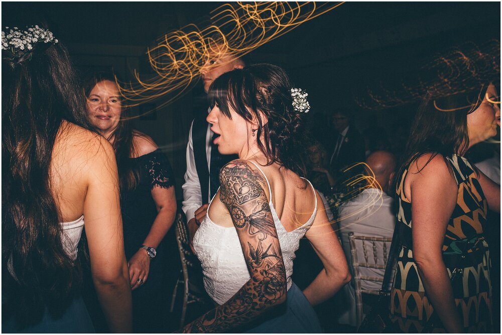 Wedding guests dance and celebrate at Quarry Bank Mill wedding in Cheshire near to Manchester.