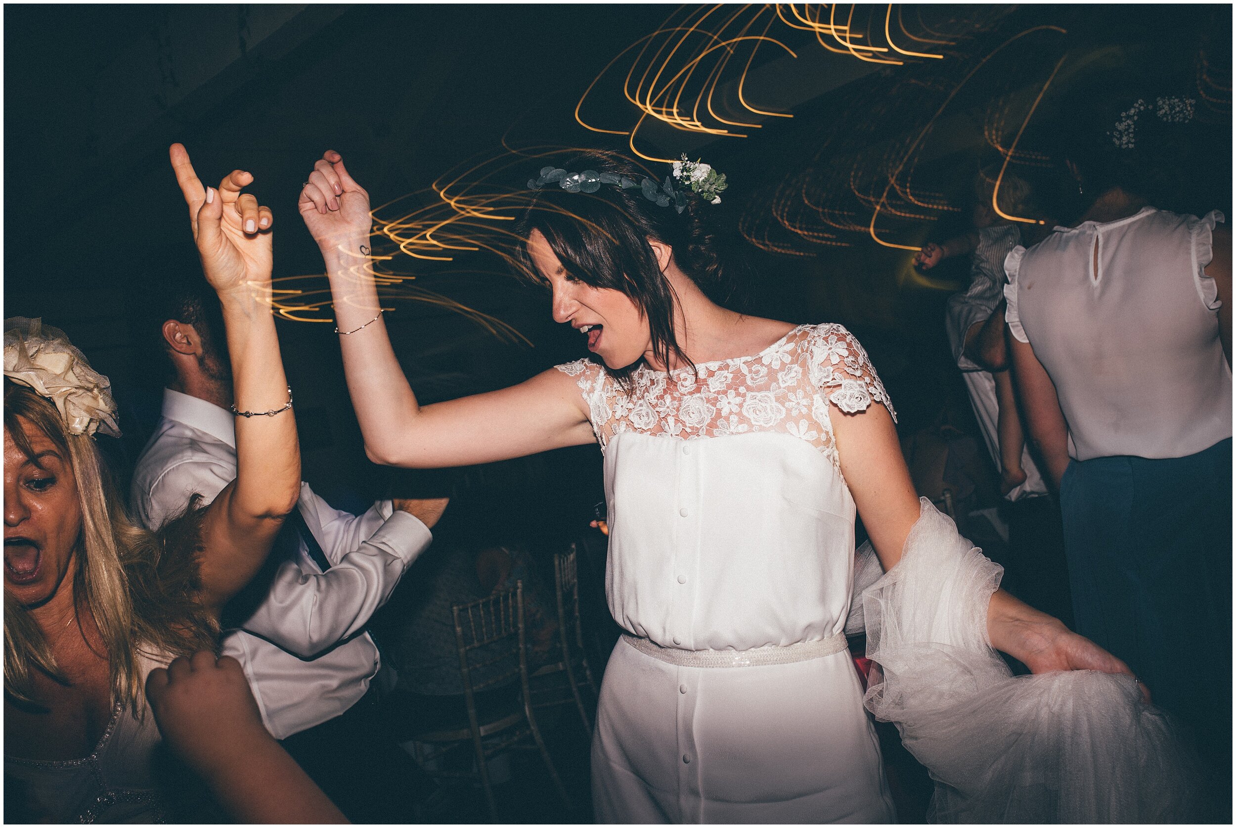 Wedding guests dance and celebrate at Quarry Bank Mill wedding in Cheshire near to Manchester.