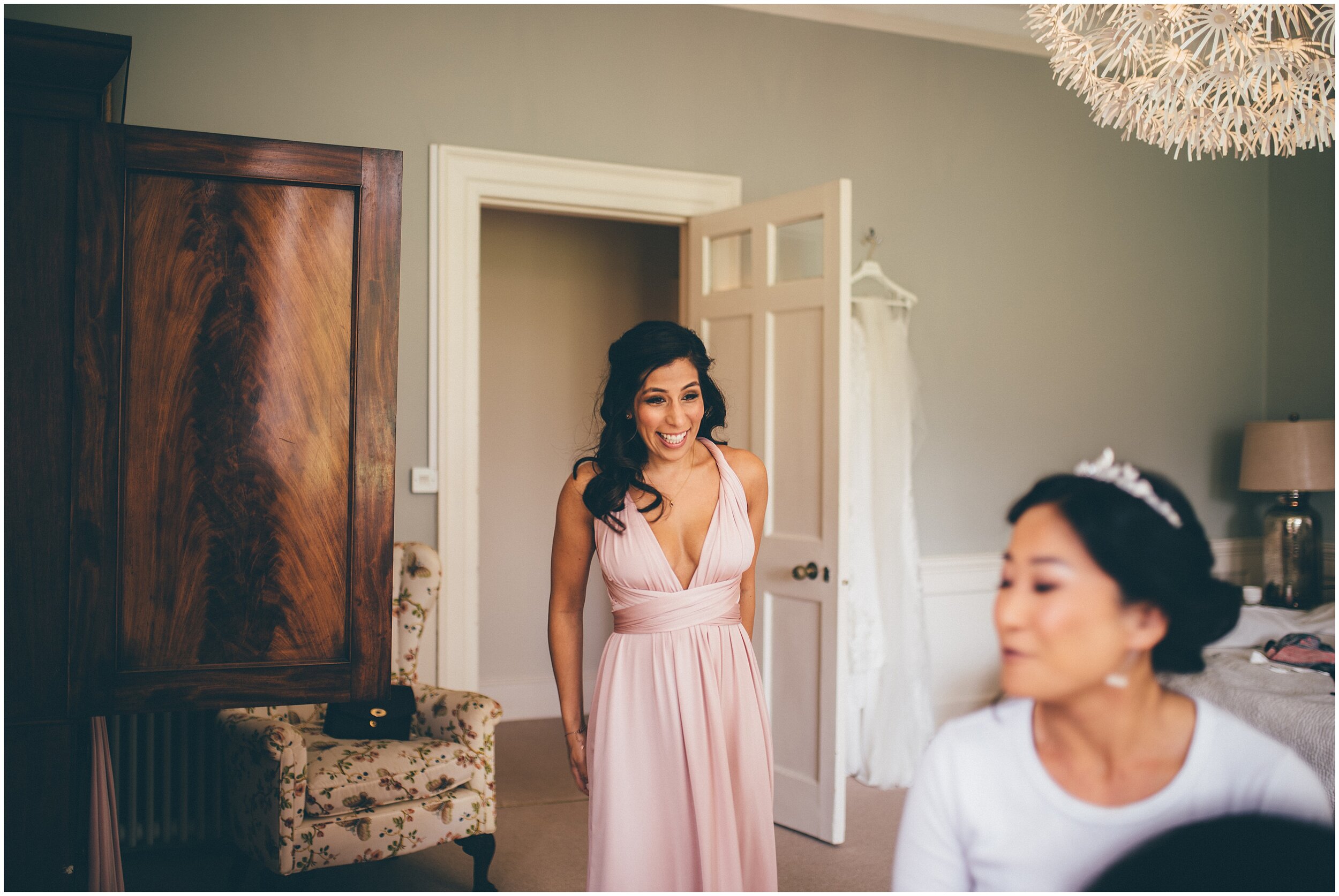 Smiling Bridesmaid sees the bride for the first time