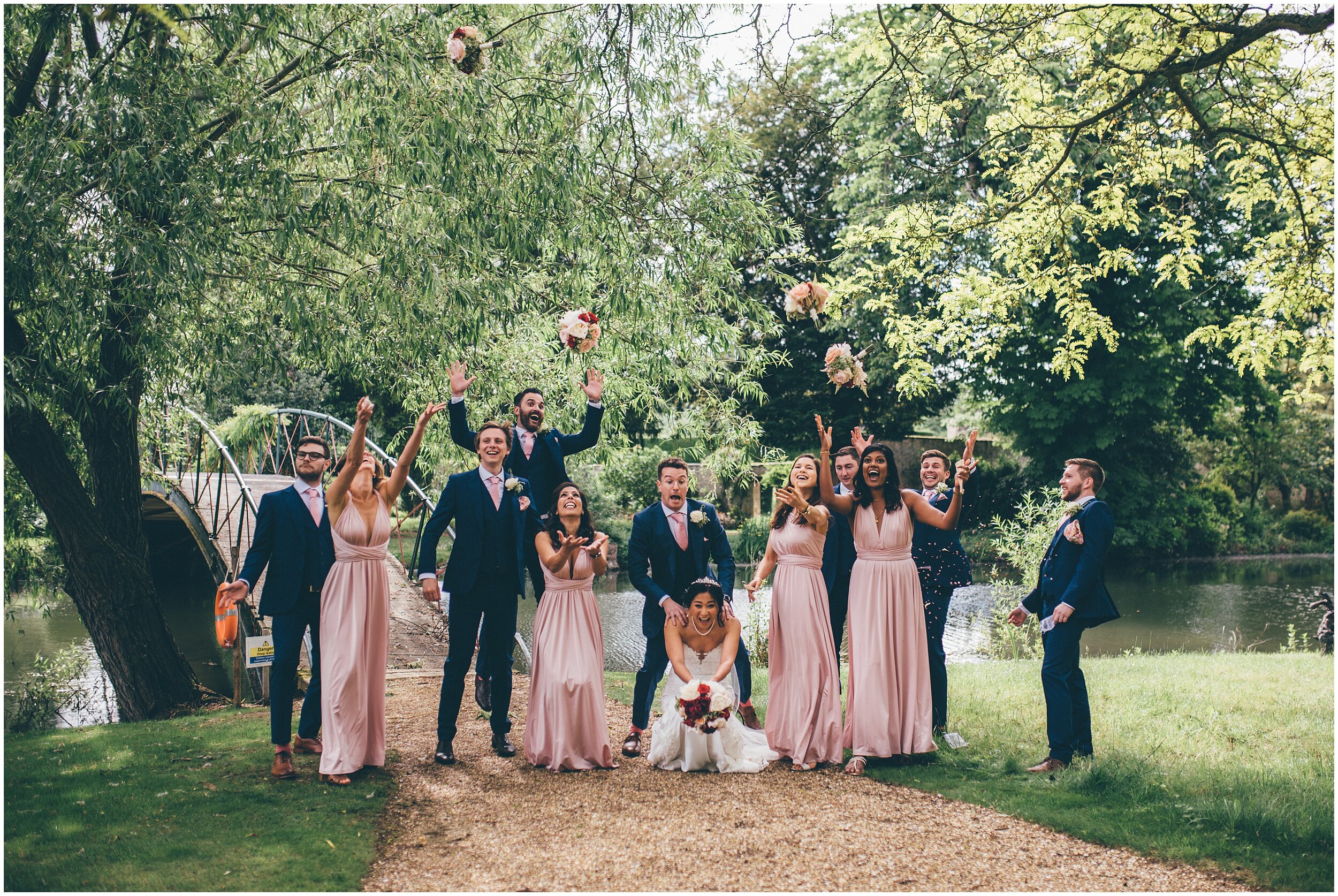 Bridal party with bridesmaids and groomsmen having fun and laughing.