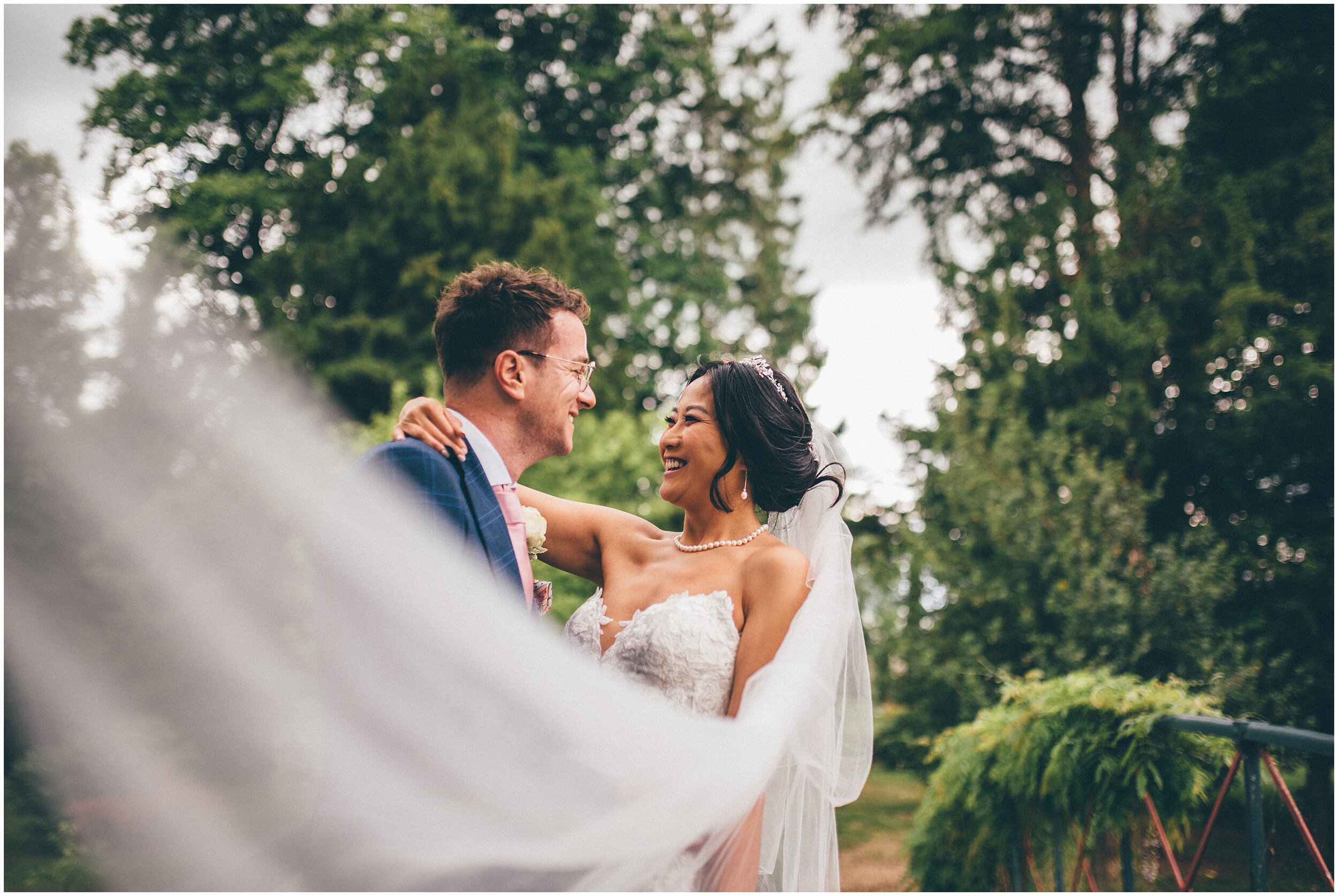 Super smiley bride with her groom at Chippenham park gardens.