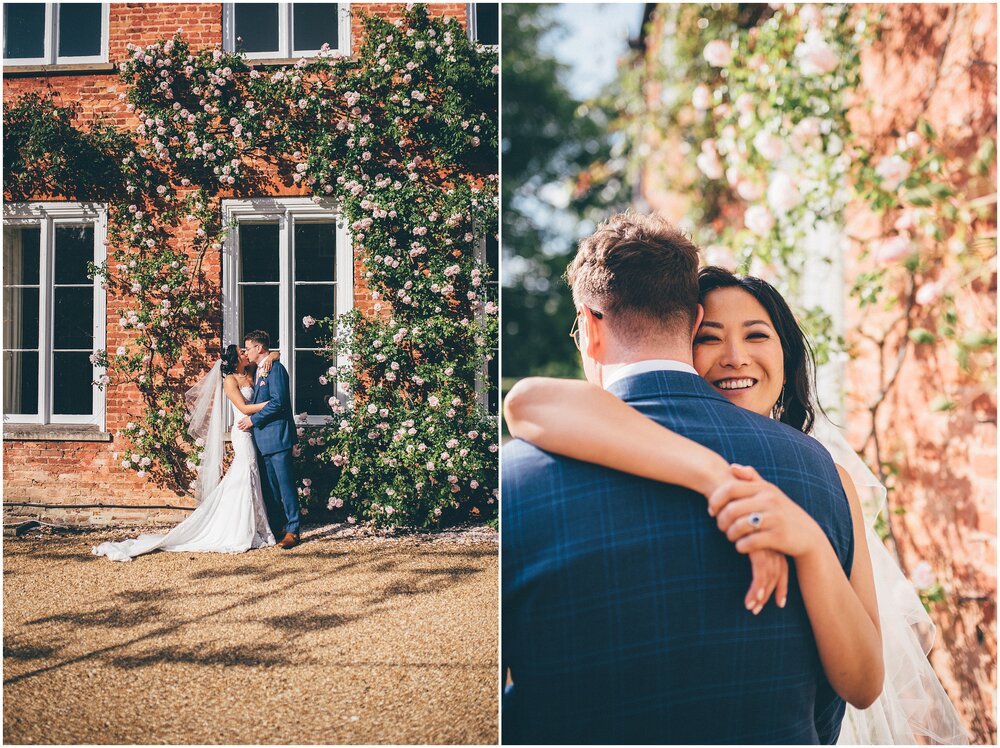 Couple cuddle in grounds of their Cheshire wedding venue.