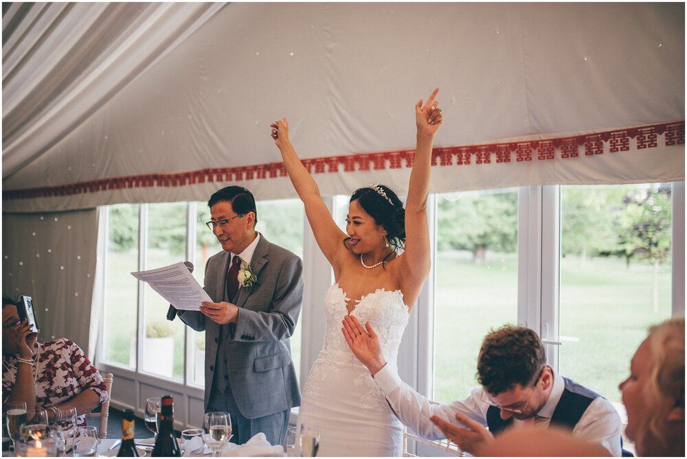 Bride cheers and celebrates during the Father of the bride wedding speech at Cheshire wedding venue.