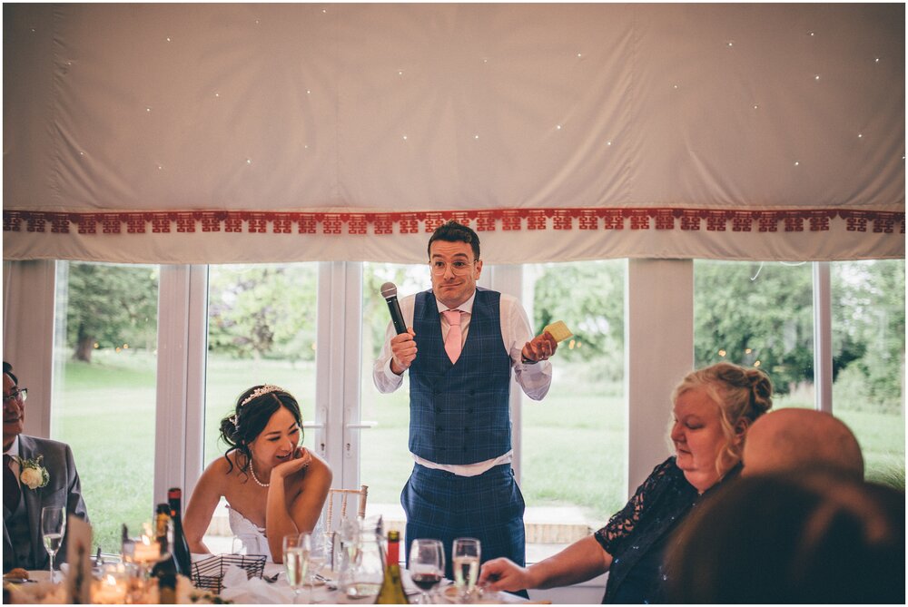 Groom shrugs and smiles during his wedding speech in Cheshire wedding venue.