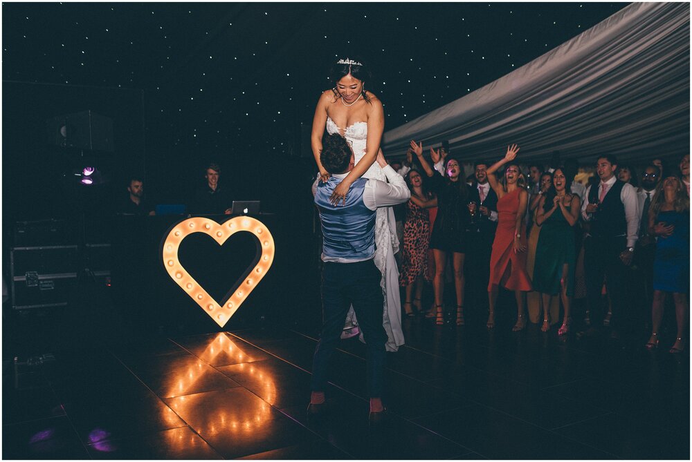 Bride is lifted by the groom during their First Dance at Cheshire wedding venue.