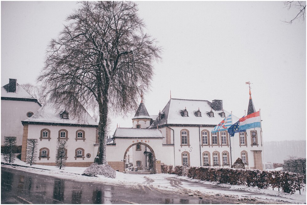 Snow covered Chateau D'Urspelt in Luxembourg at a destination wedding.