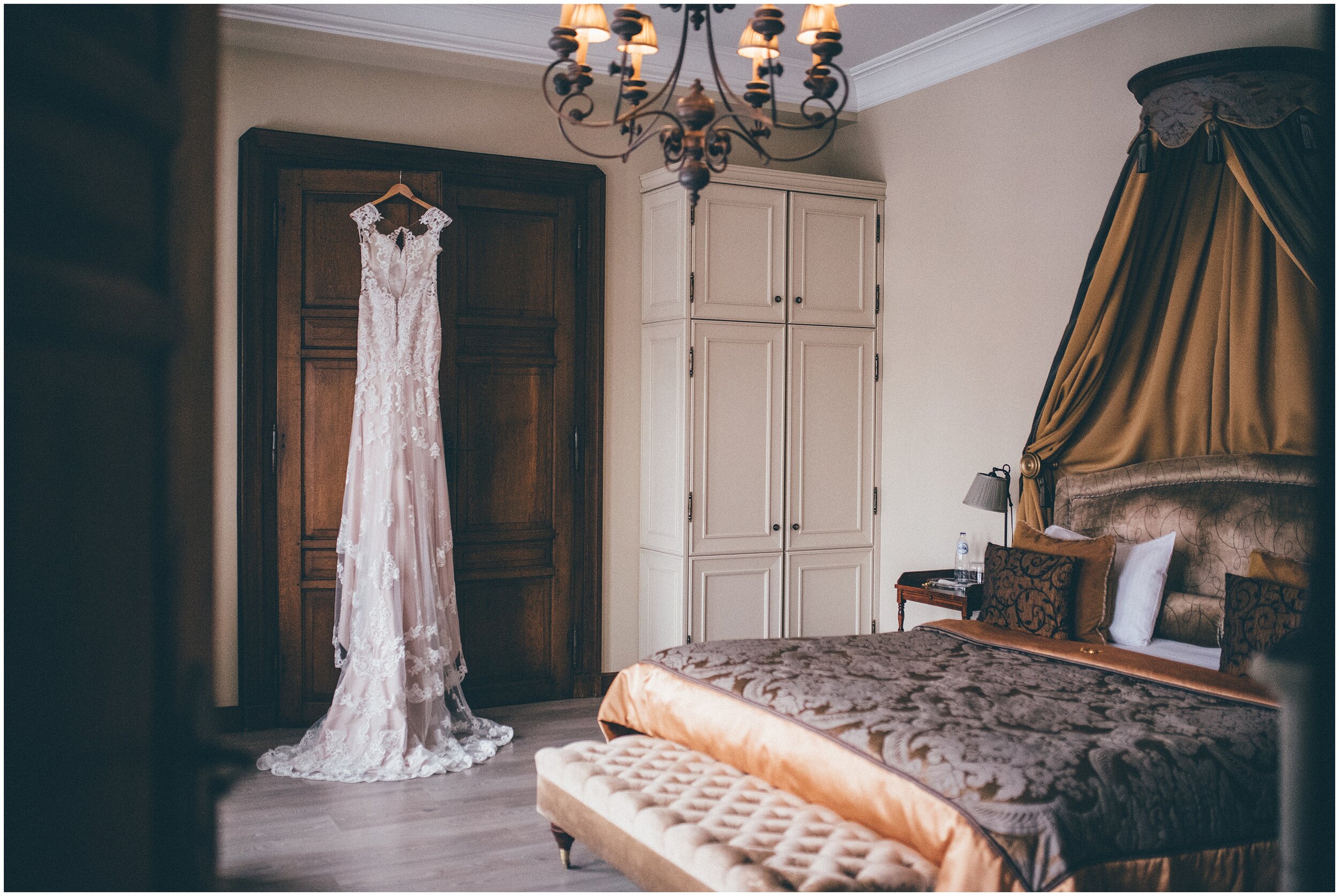 Lacy Essence of Australia gown hung up in the bridal suite of a snowy castle in Luxembourg