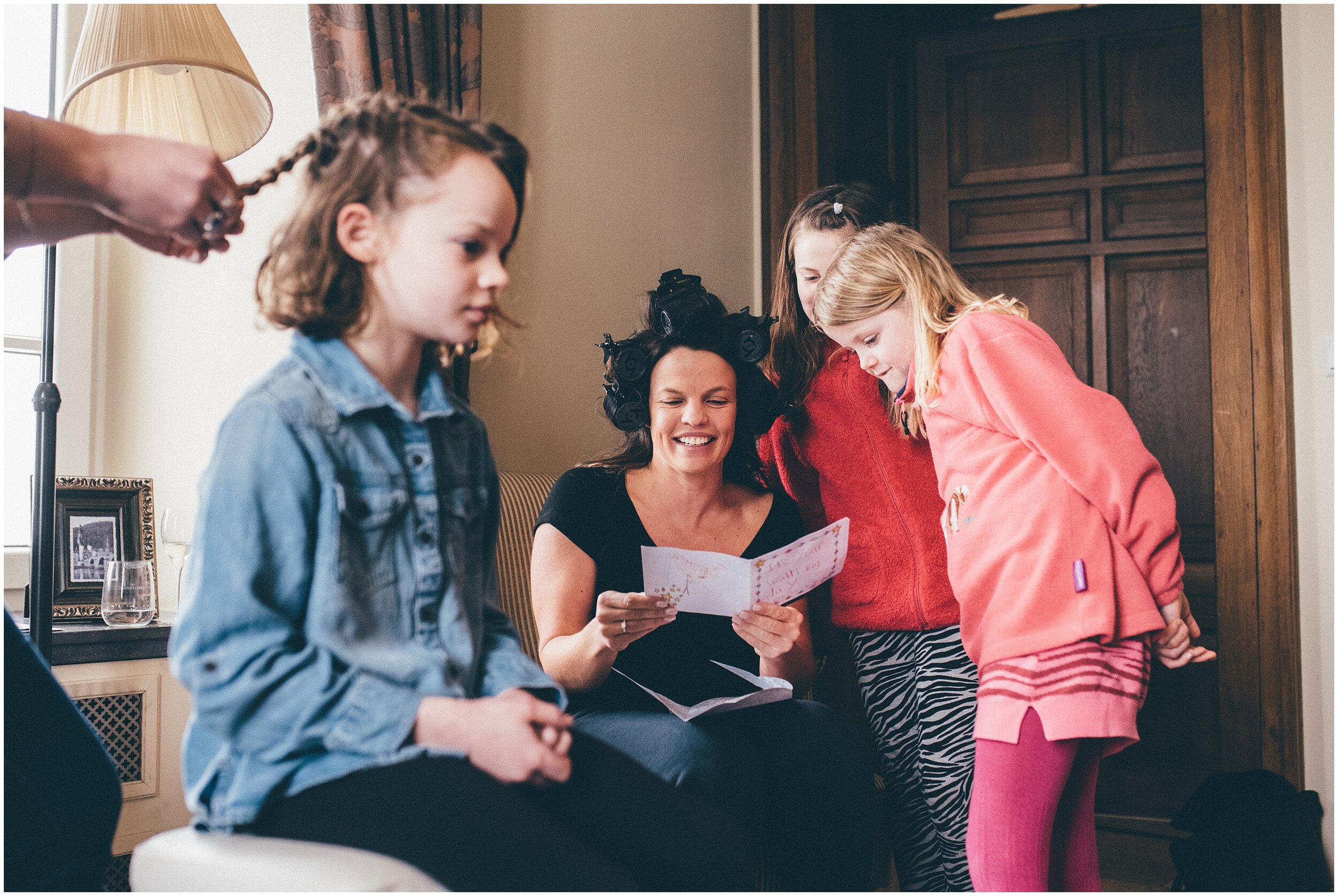 Bride receives a card from her flower girls at her winter wedding.