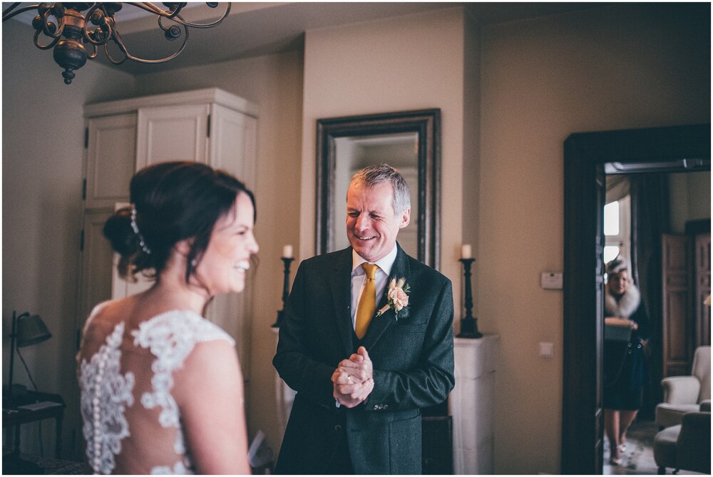 Bride's dad sees her in her wedding dress for the first time.