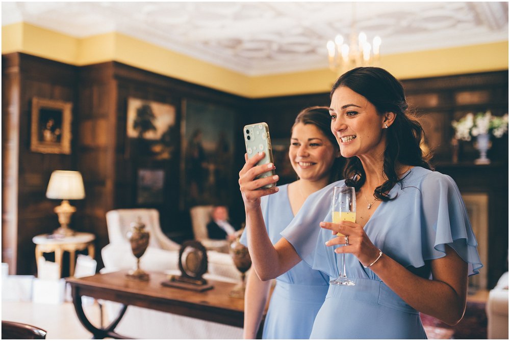 Bridesmaids FaceTime friend before the wedding day.