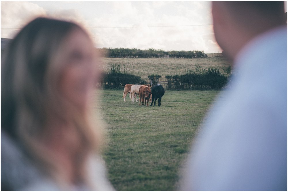 Bride and Groom walk through fields at Tower Hill Barns in North Wales