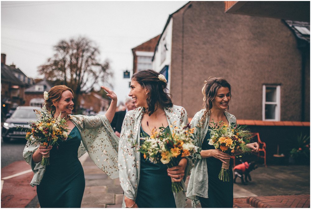 Bridesmaids walk to the wedding in Tarporley, Cheshire
