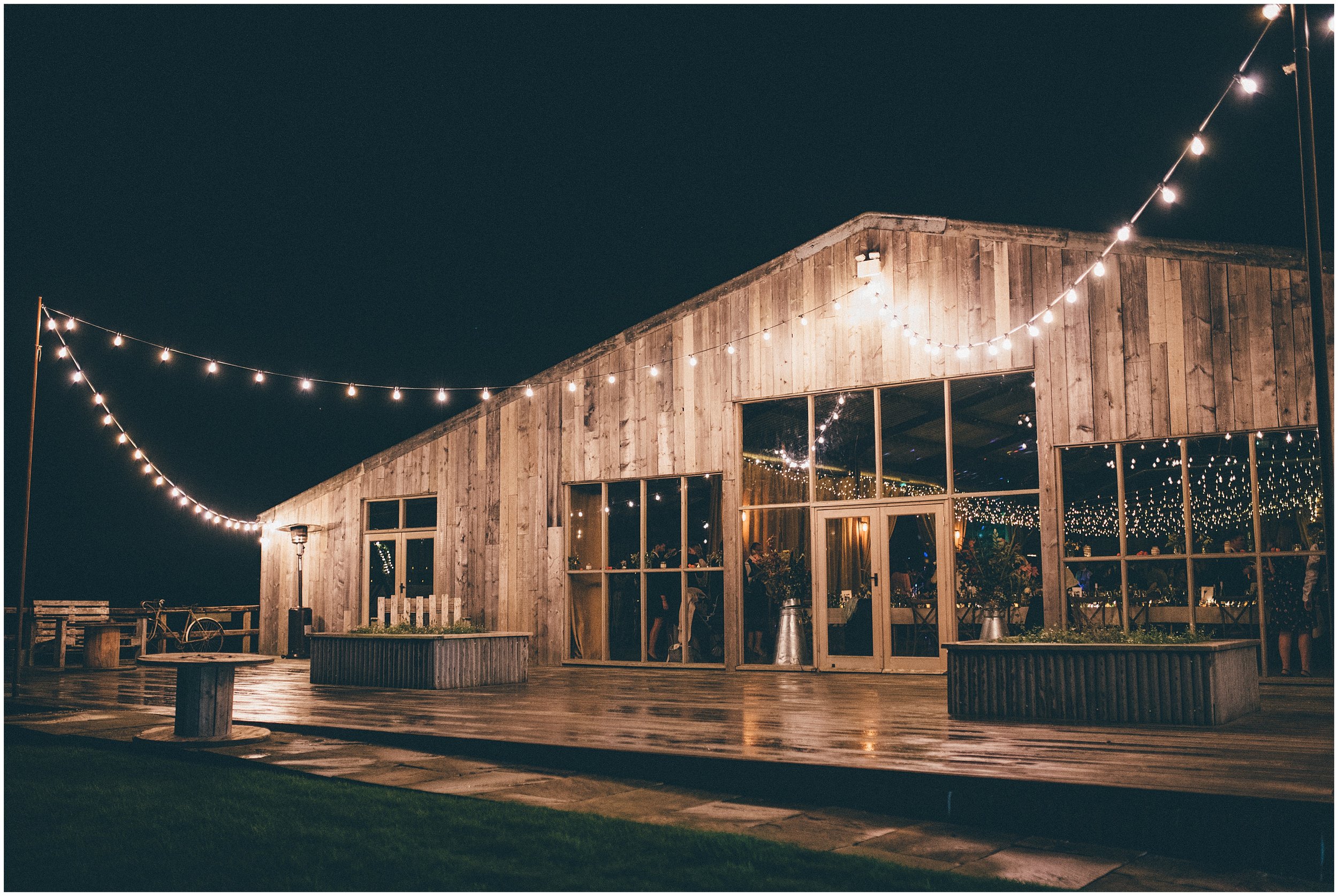 Grange Barn lit up with fairy lights in Autumn