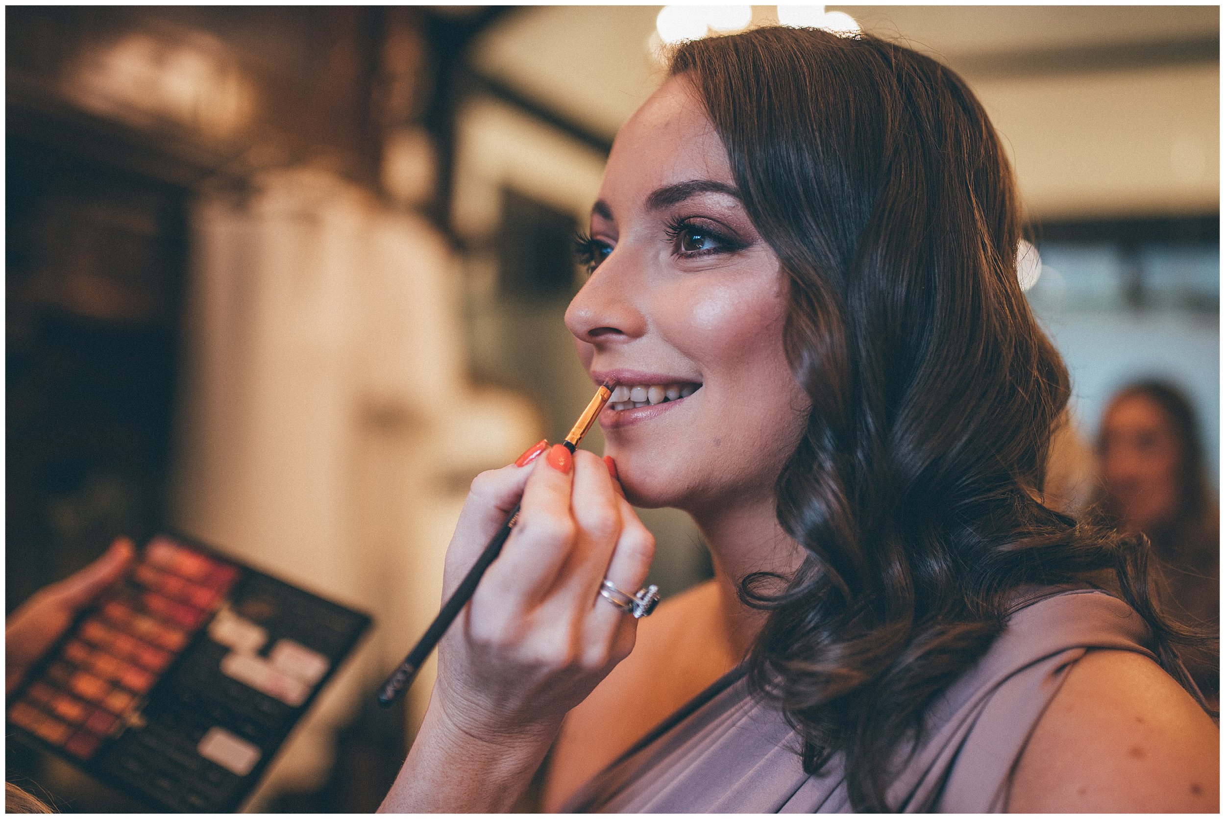 Bridesmaid gets her make-up done on wedding morning at Tyn Dwr Hall