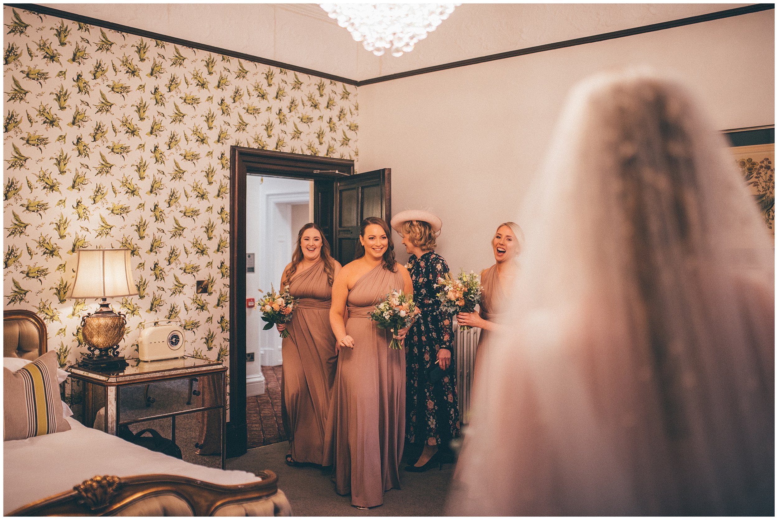 Bridesmaids see their friend as a bride for the first time