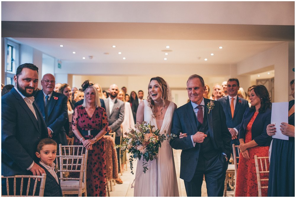 Bride walks down the aisle with her Dad at Tyn Dwr Hall