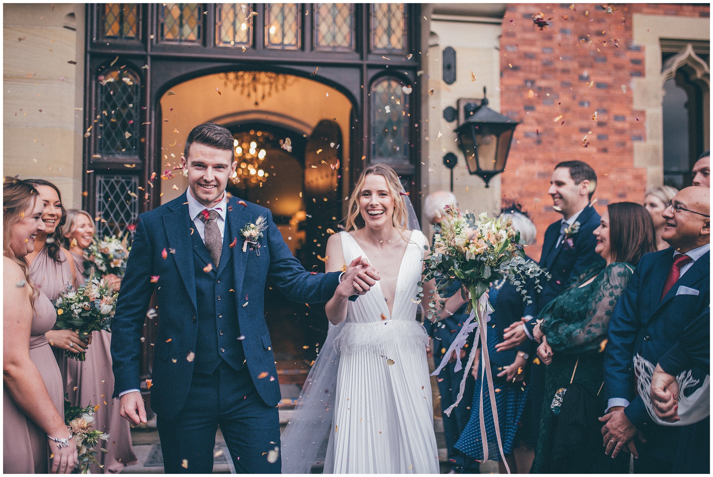 Confetti gets thrown over the bride and groom at Tyn Dwr Hall