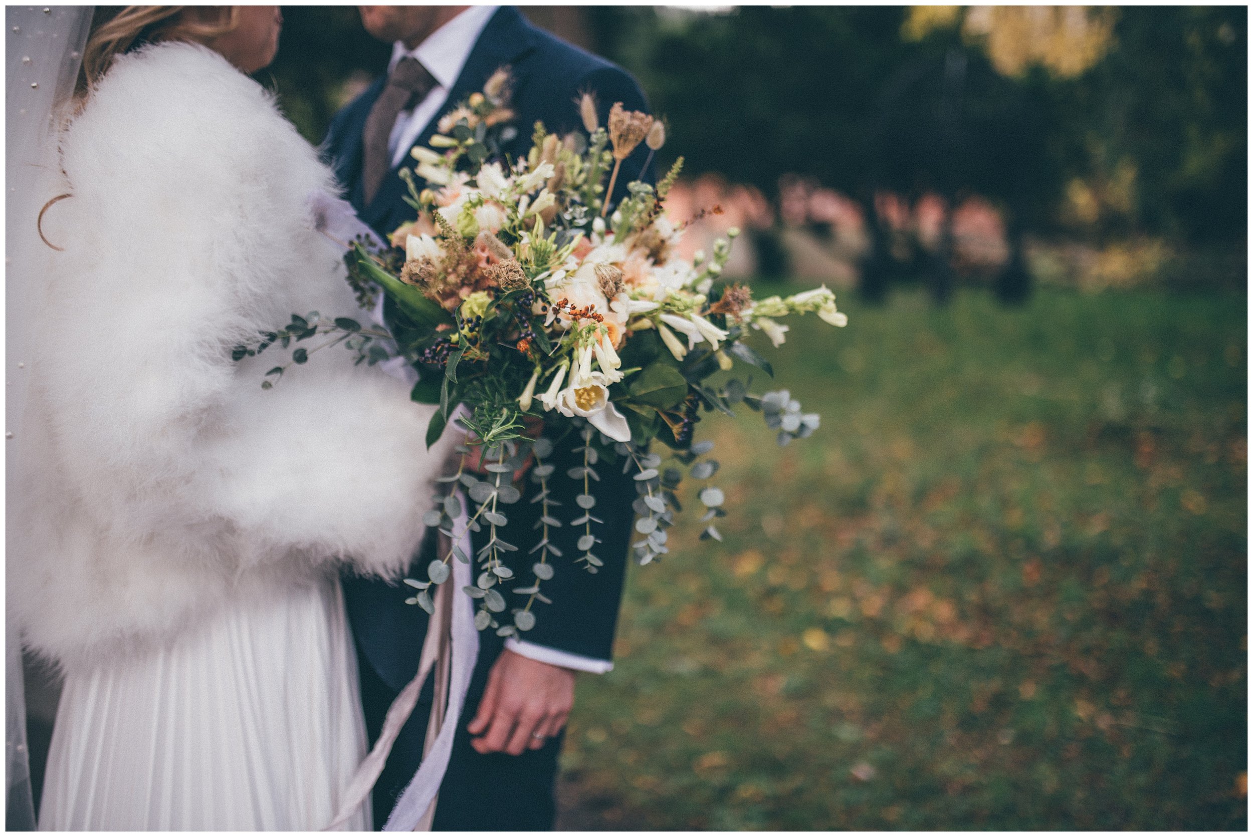 Newlyweds walk around their wedding venue, Tyn Dwr Hall, having photographs taken but their Cheshire wedding photographer