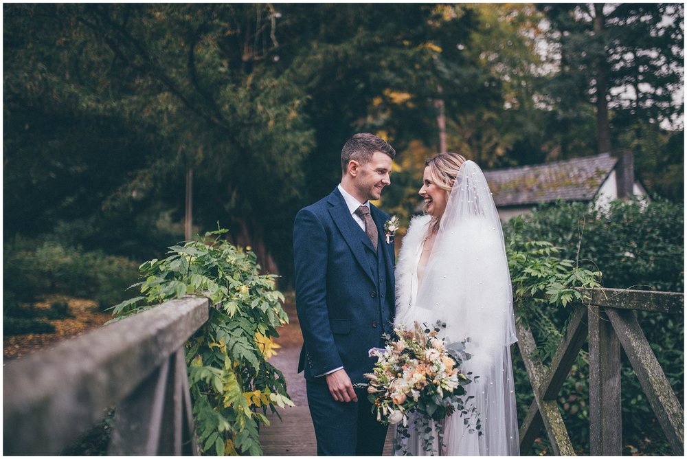 Newlyweds walk around their wedding venue, Tyn Dwr Hall, having photographs taken but their Cheshire wedding photographer