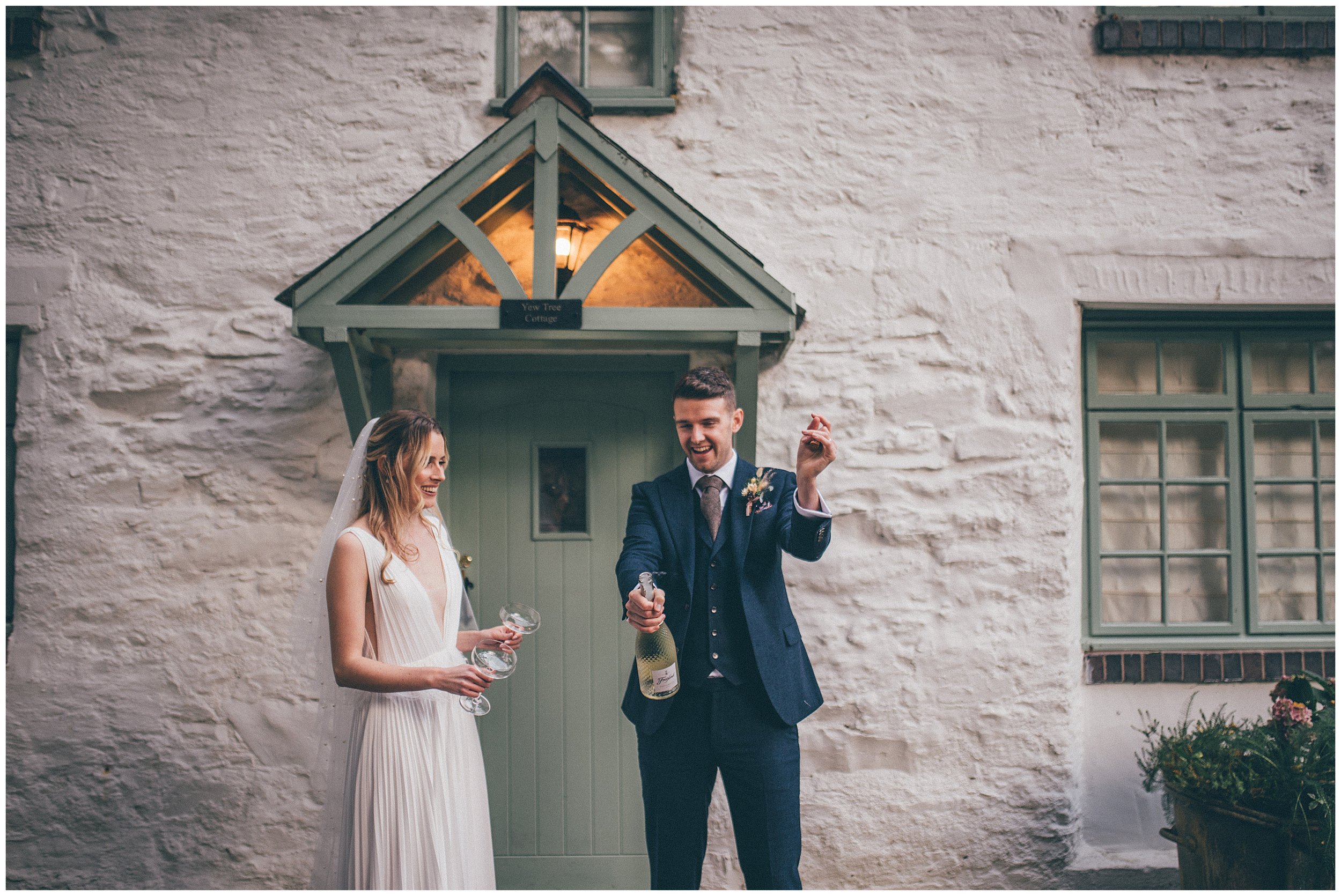 Newlyweds walk around their wedding venue, Tyn Dwr Hall, having photographs taken but their Cheshire wedding photographer