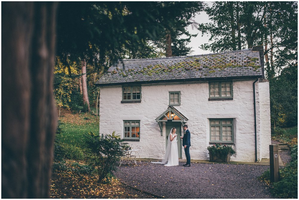 Newlyweds walk around their wedding venue, Tyn Dwr Hall, having photographs taken but their Cheshire wedding photographer