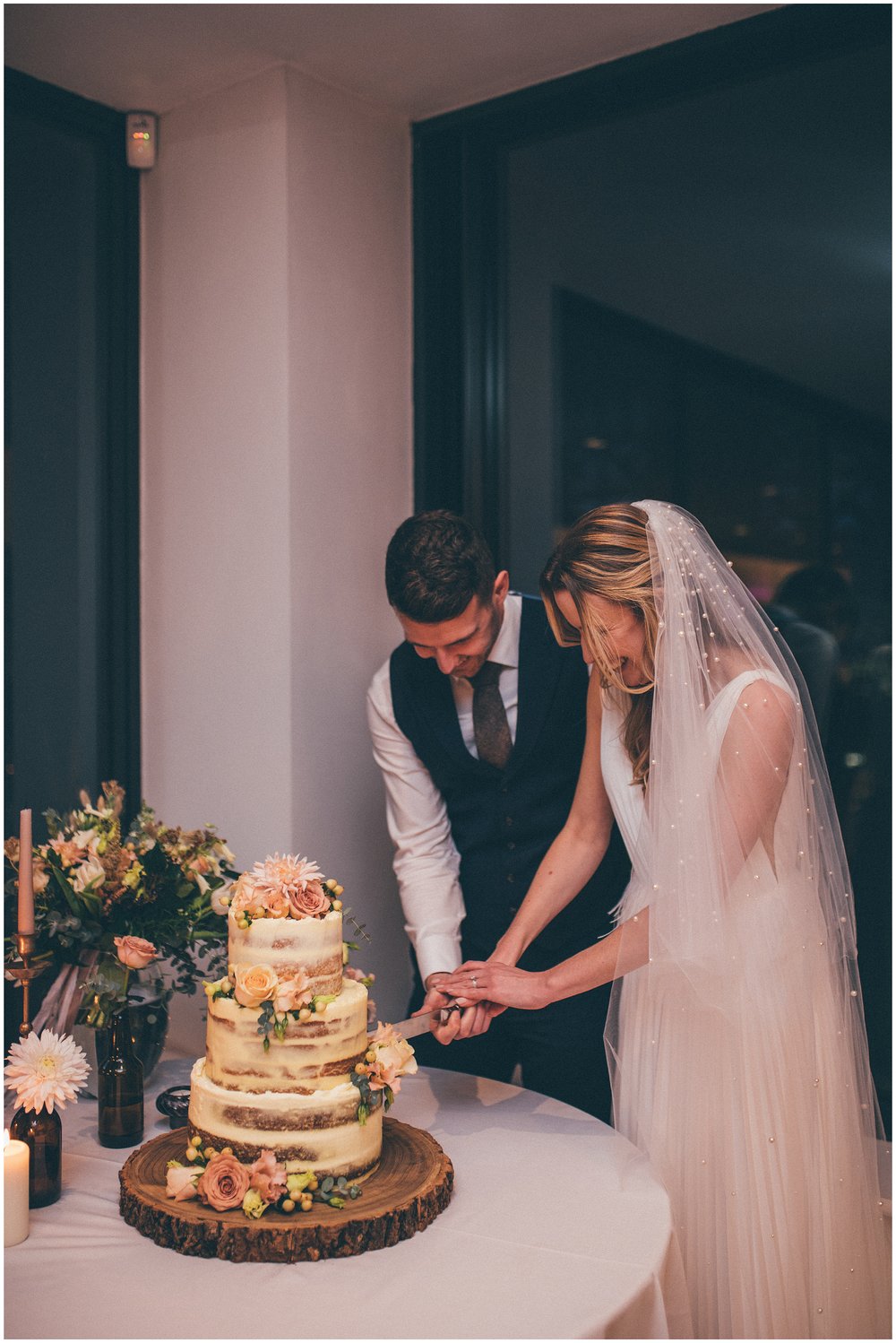 Bride and groom cut their wedding cake at Tyn Dwr Hall in North Wales