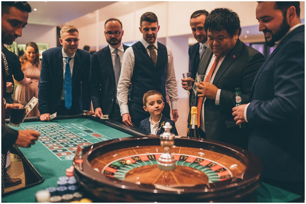 Guests enjoy Poker Table and roulette table at Tyn Dwr Hall wedding