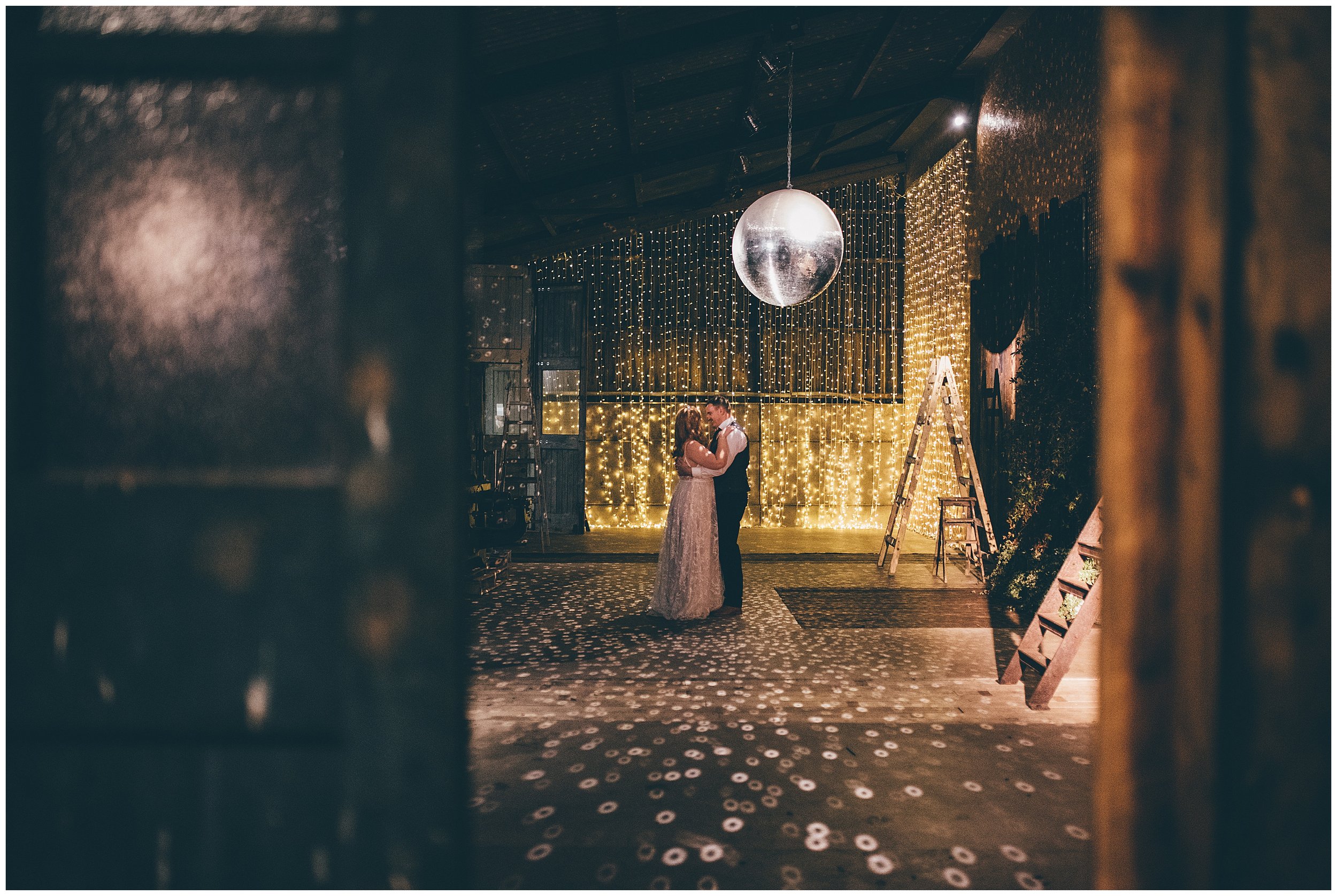 Couple dance under the disco ball at Owen House Barn