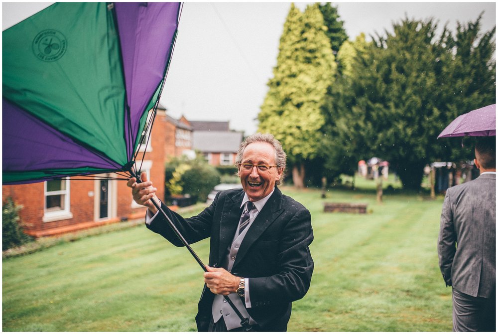 Guests umbrella blows inside out at Cheshire wedding