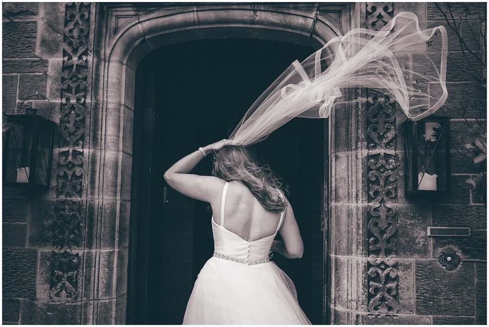 Bride's veil flies in the wind at Wirral wedding