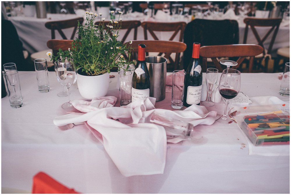 Red wine spilt all over the table at marquee wedding in Suffolk