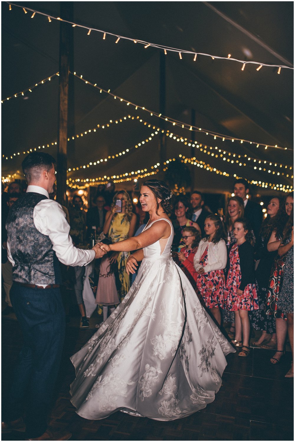 Groom twirls his bride at marquee wedding in Suffolk