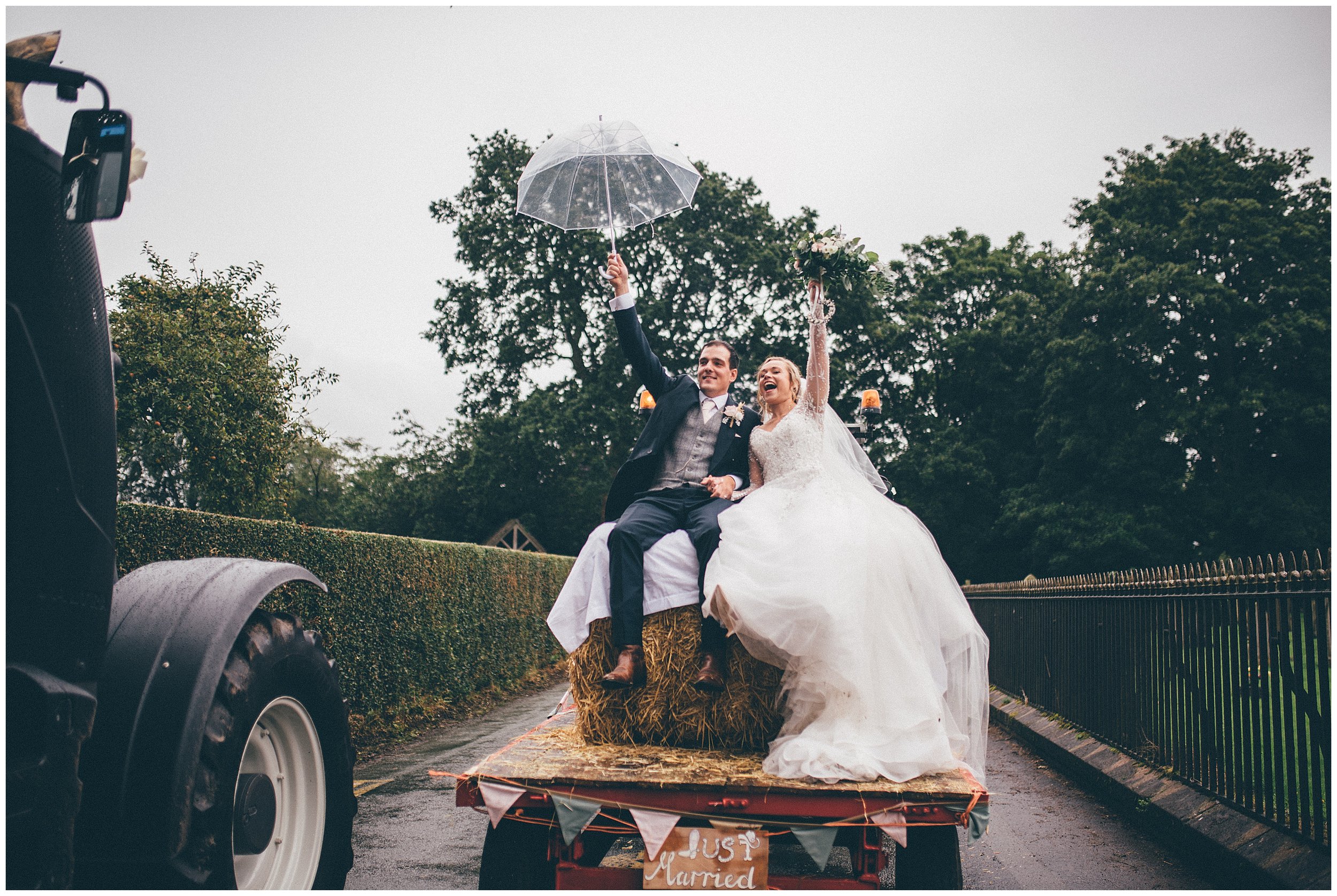 Bride and groom celebrate being Just Married on the back of a tractor