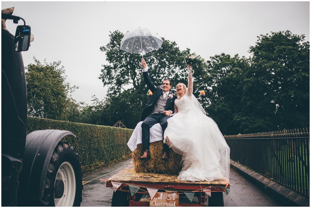 Bride and groom celebrate being Just Married on the back of a tractor