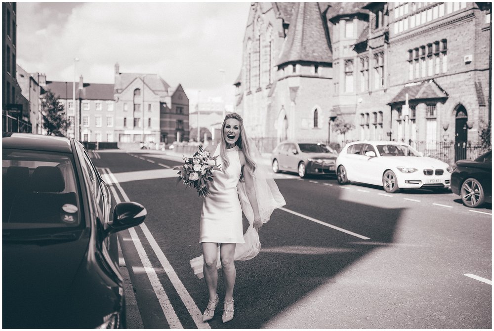 Bride arrives at her Chester city centre wedding in a mini silk wedding dress