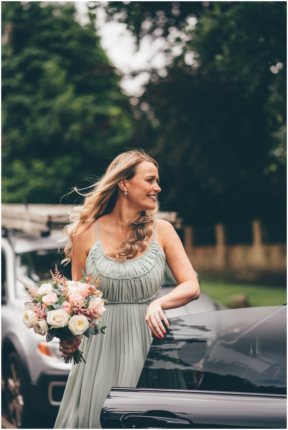 Bride arrives at her wedding ceremony in beautiful sage green dress