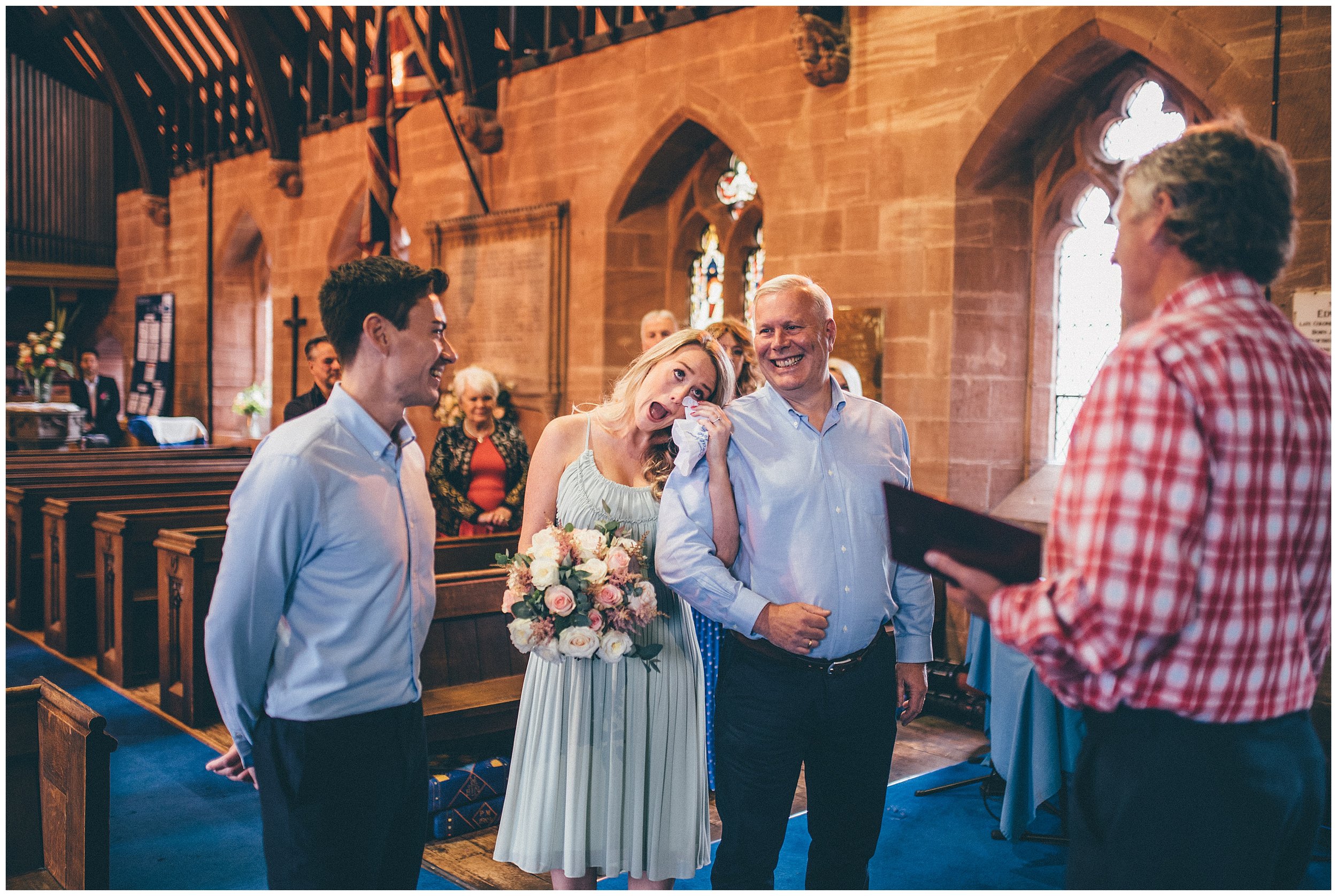 Bride cries as she gets to the top of the aisle with her dad during their covid wedding