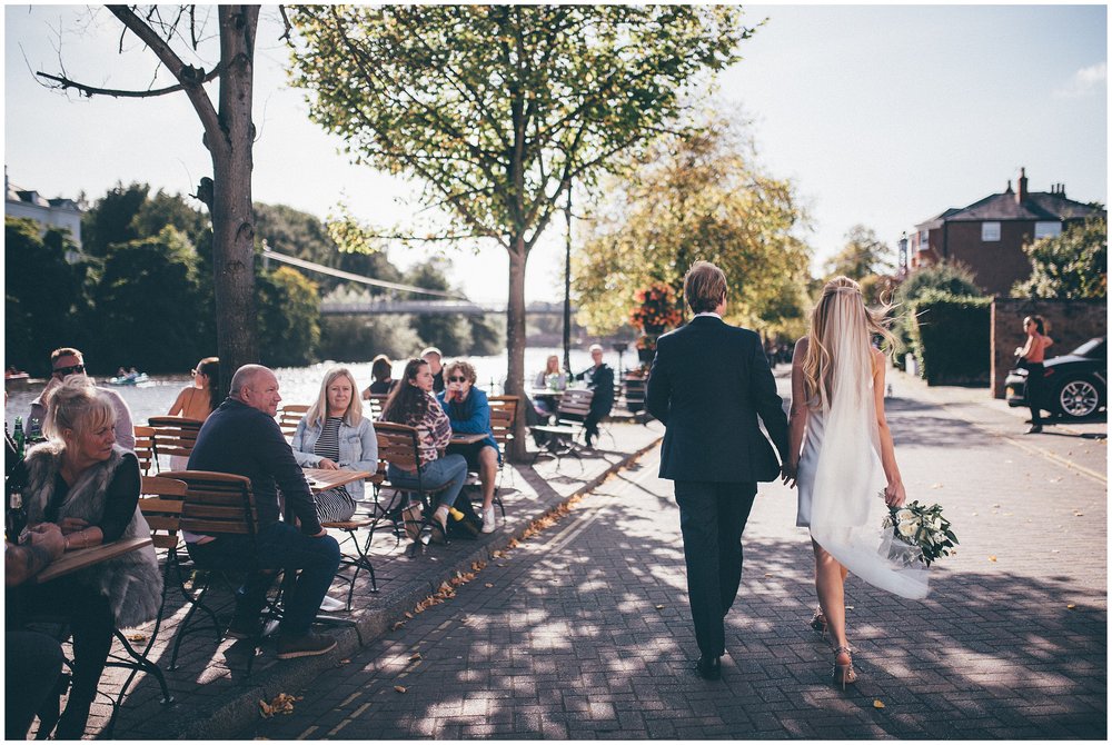 Newlyweds walk through the streets of Chester, bride wears a slinky mini wedding dress