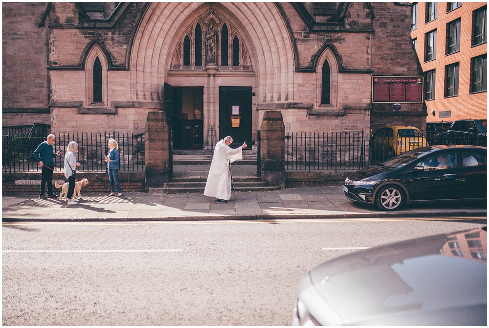 Vicar does a Thumbs up to a car parking at the church