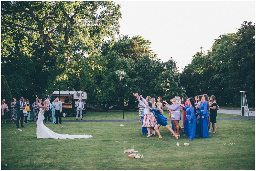 Bride throws her bouquet at Bodryhddan Hall