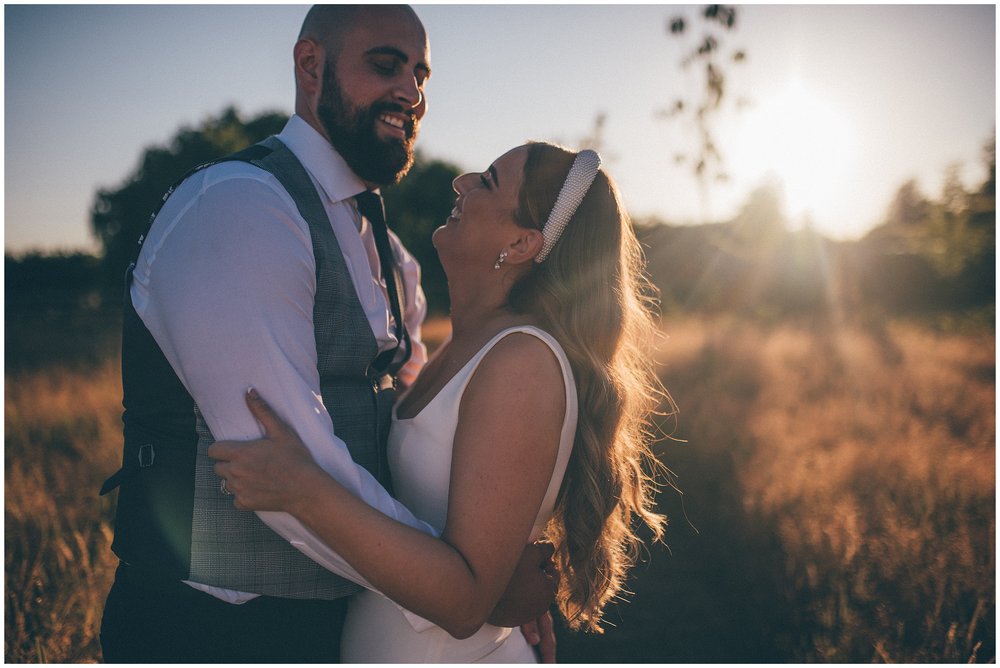Bride and groom laugh together in golden hour at The Oakwood at Ryther wedding