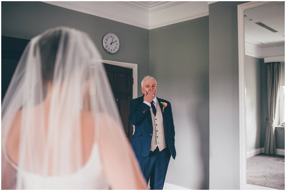 Father of the bride gets very emotional as he sees his daughter in her wedding dress for the first time